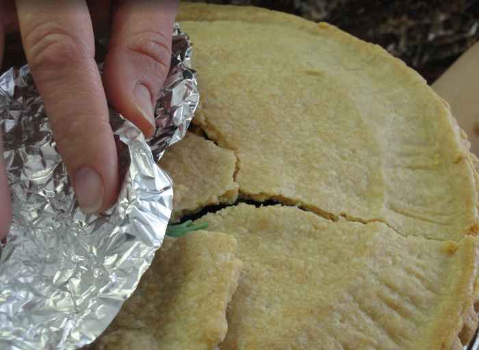 Cooked pie crust with toy frog leg sticking out