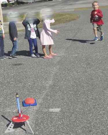 Taking turns shooting off stomp rockets -