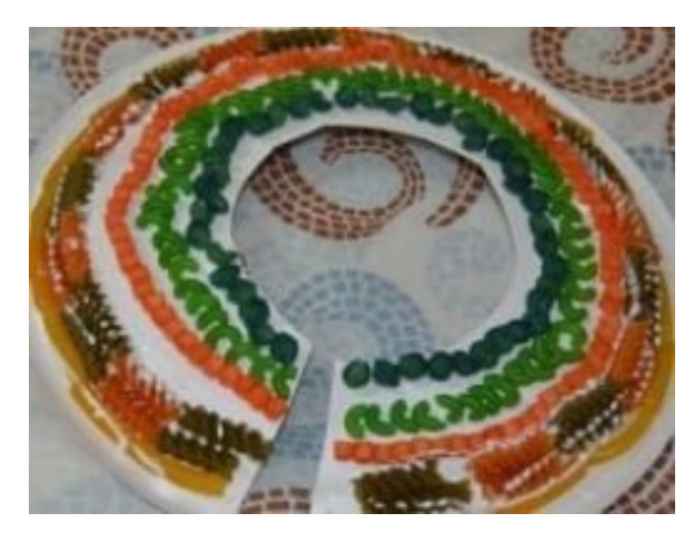 "Beaded" necklace made with a sturdy paper plate, glue, & colored pasta