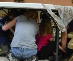 Cramming together in the "steerage" during the dramatizing of arriving at Ellis Island - Photo taken by Michelle Harrison, who participates in our class