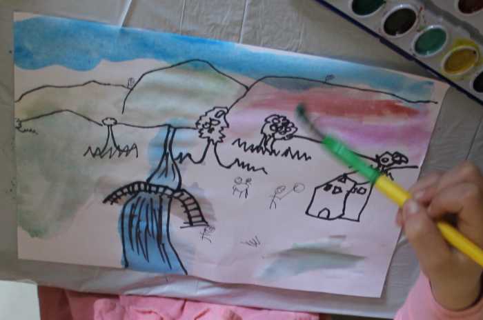 Using watercolor paints to finish the Grandma Moses inspired picture - CC Cycle 3 Week 13 Fine Arts