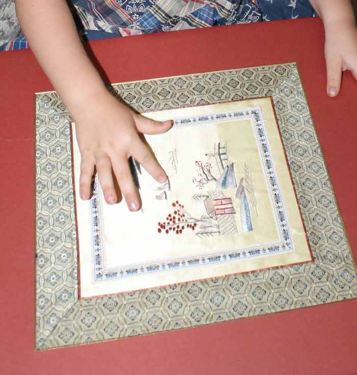 Examining Chinese embroidered silk