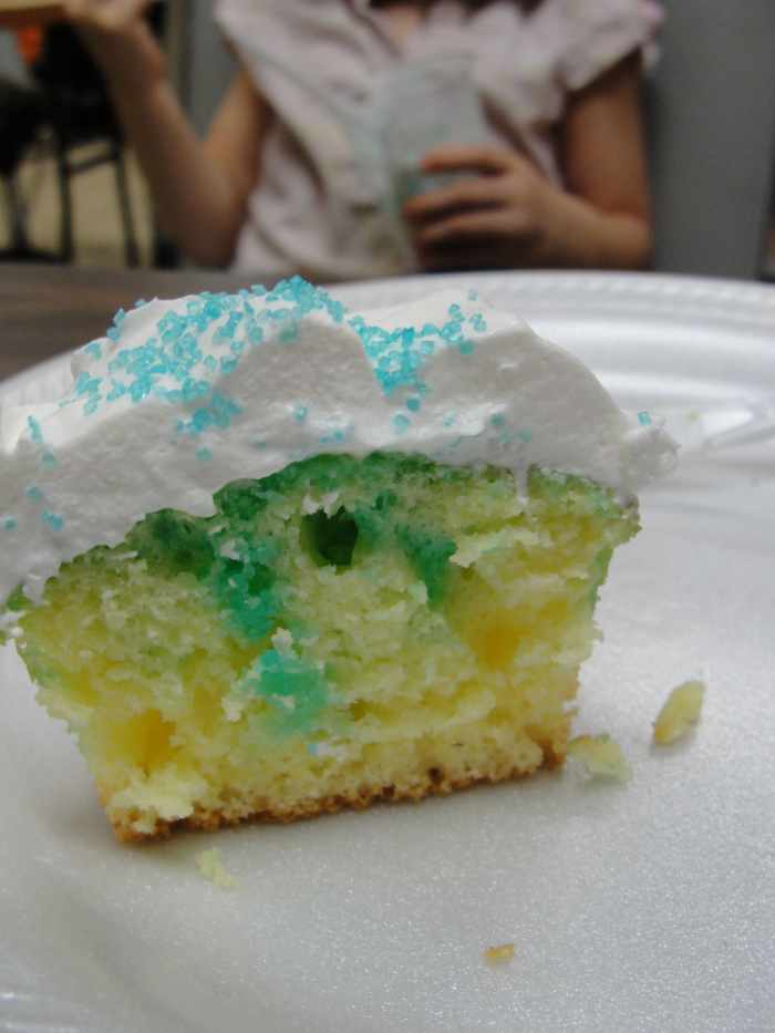 Raindrop cupcakes made by poking baked cupcakes with a toothpick and drizzling with liquid blue jello (that hasn't solidified yet) and topped with Cool Whip and blue sprinkles