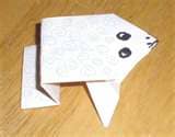 Origami frog close up made with white paper
