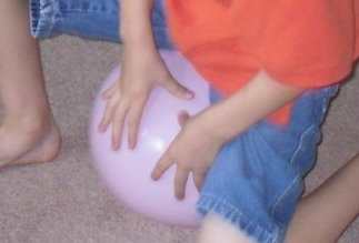 Popping a balloon to show what causes thunder