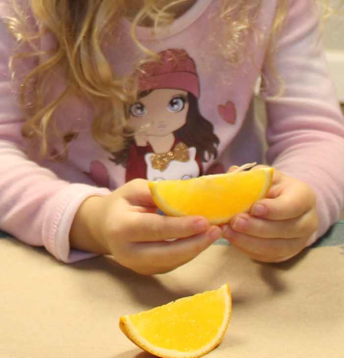Eating oranges, high in Vitamin C