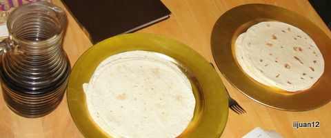 "Table of Shewbread" with 2 stacks or tortillas on gold plate chargers along with a pitcher of "wine"