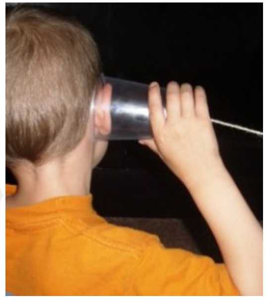 Cup phone used to learn about how sound waves travel from the first lesson in this unit study on hearing and sound waves