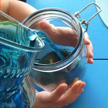 Filling a jar with sand and blue water to represent the Earth - Image credit: http://www.cbc.ca/parents/play/view/activity_for_kids_make_an_ocean_in_a_jar