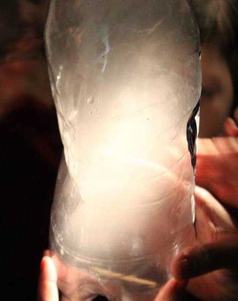 Cloud in a bottle (with the lights turned off an a flashlight shining on it)