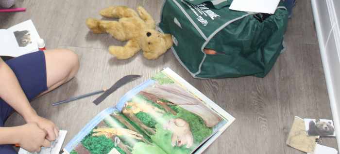 Bag of snacks, canoe oars, & "grizzly bear" teddy bear with construction paper 7-inch claws