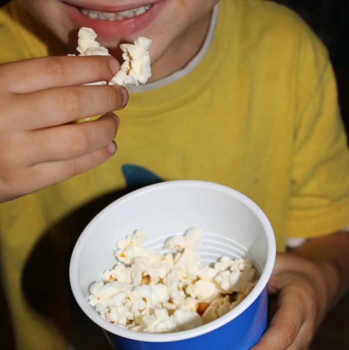 Eating popcorn and turkey to remember what was eaten at the first Thanksgiving meal