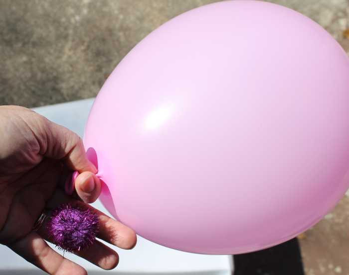 Using a balloon and craft pompoms to demonstrate how viruses replicate themselves