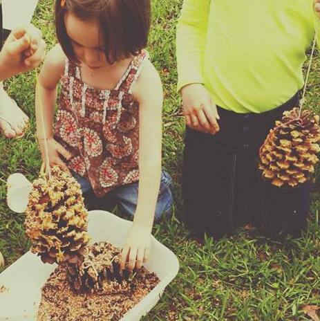 Making pine cone bird feeders (Photo taken by Victoria, who participates in our co-op class)