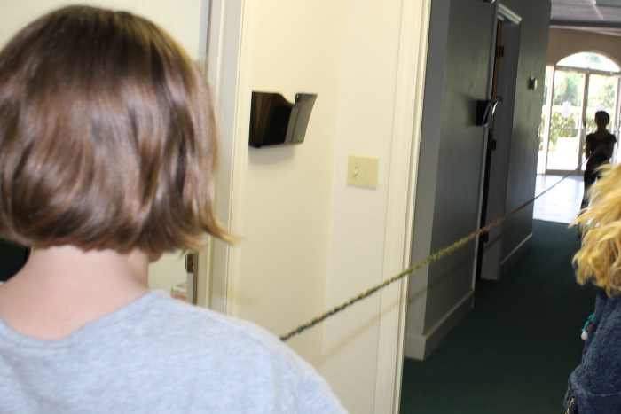 Holding a piece of yarn that is 20 feet to show the length of the small intestine