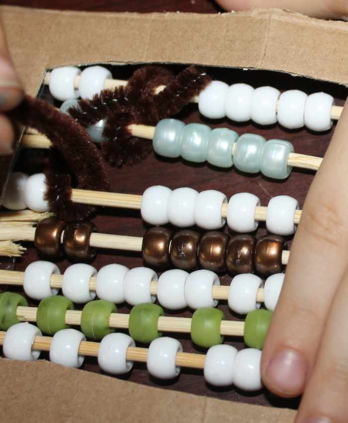 Children creating a Chinese abacus