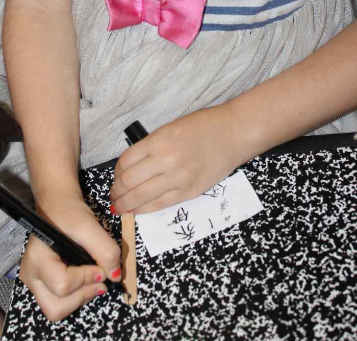 Each child attempted to write their name in Chinese characters on their "bamboo" slip made from a craft/popsicle stick.