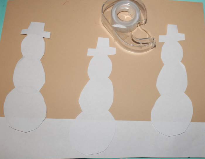 Taping the snowmen to the snow