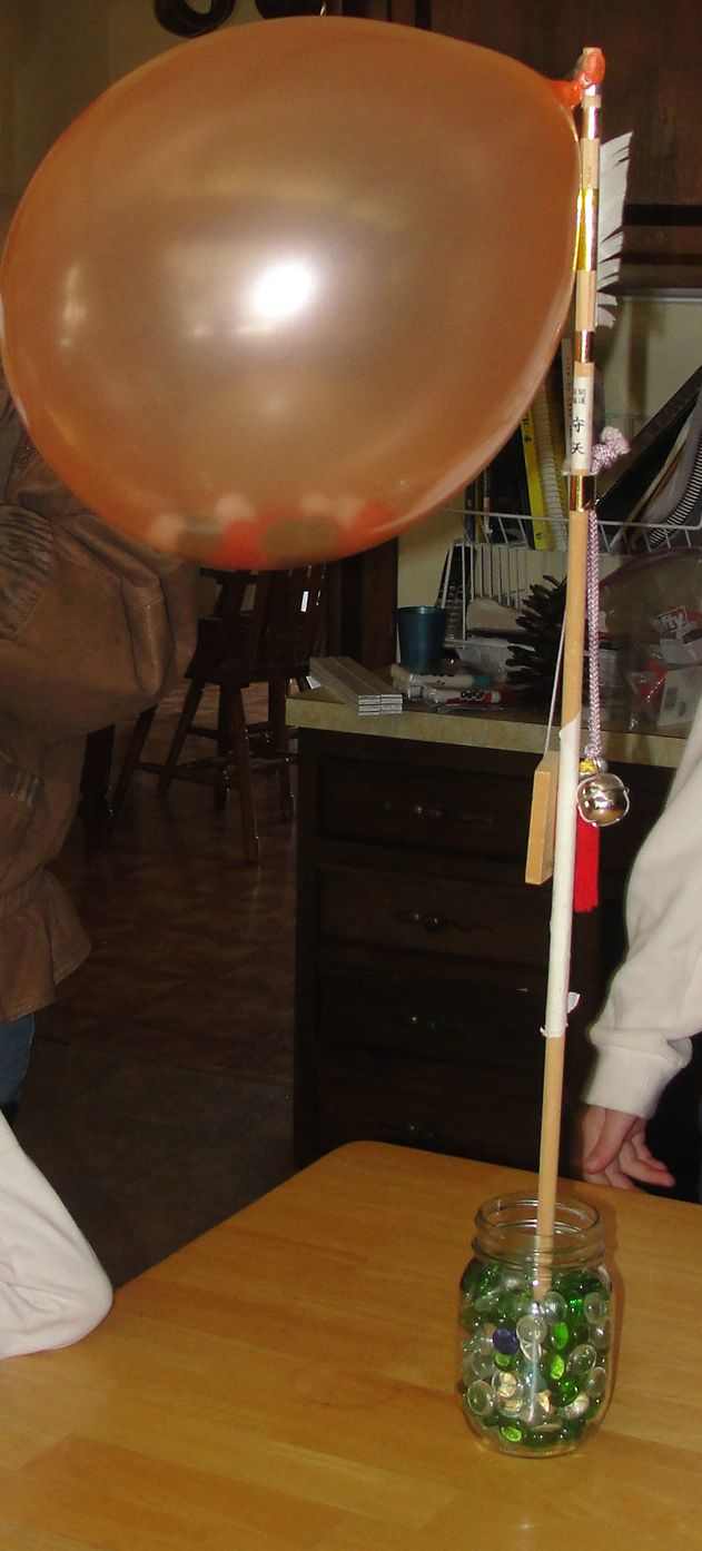 Showing how yeast buds using a balloon and pom poms 