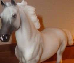 Going through the parts of a horse using a toy horse