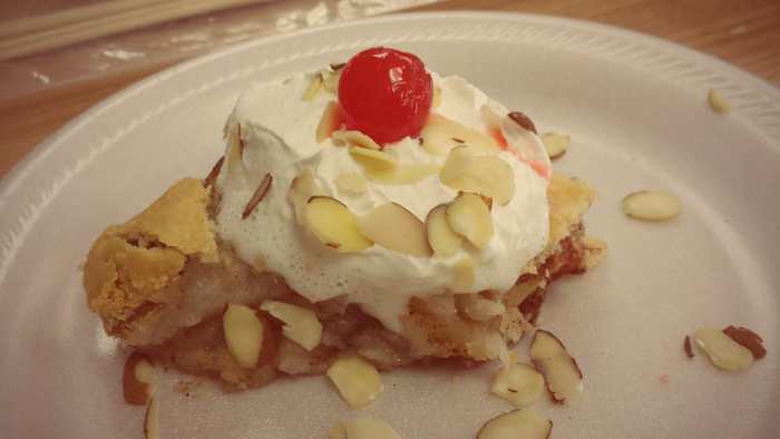 This photo of the Washington apple pie with Oregon cherries and California dairy whipped cream and almonds was taken by Victoria, one of the mothers in our co-op class.