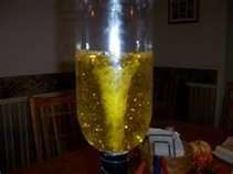 Tornado in a bottle.  You will only get this dramatic funnel by using a tornado tube (or duck tape securely placed between two 2L bottles).  However, you can still create a nice tornado just by swirling around the water in a regular bottle.