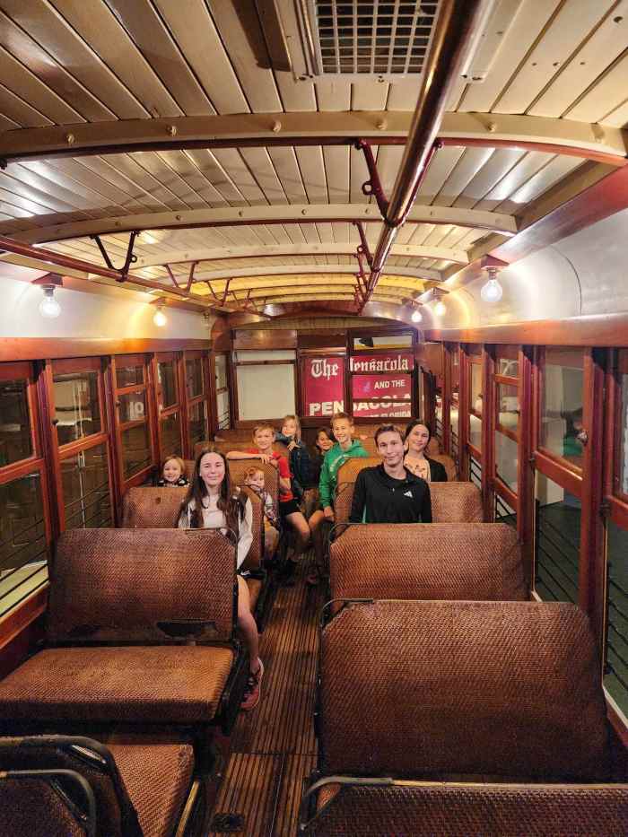 Sitting inside the historic trolley car at the Pensacola Museum of Commerce