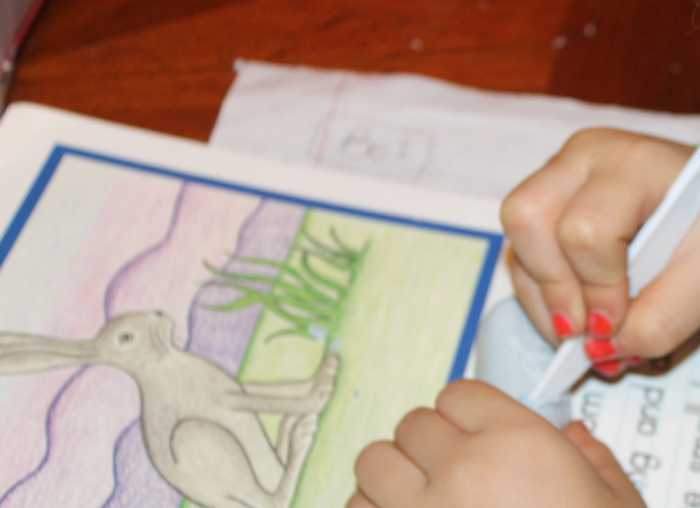 A kindergarten-aged child carving a "jade" hare from Irish Spring soap