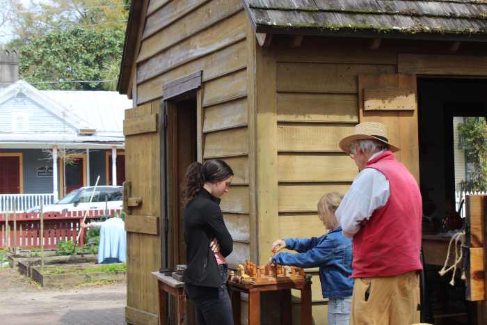 Playing chess on the handmade chess board at the Recreated 1805 Kitchen House