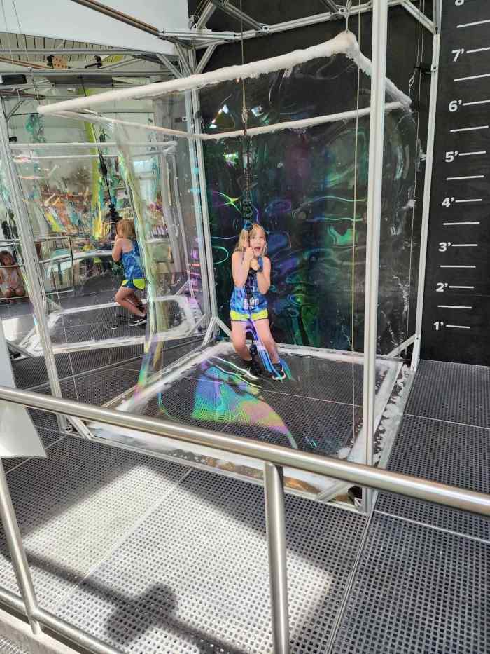 Pulling a bubble around yourself at the Louisiana Children's Museum 